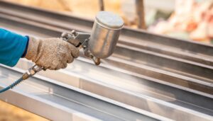 construction-worker-painting-metal-structure-surfa